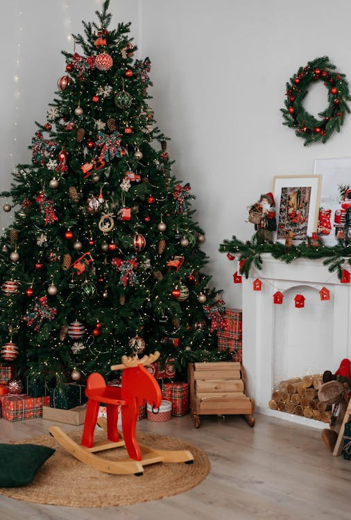 Original image of a festive living room featuring a beautifully decorated Christmas tree and cozy fireplace.